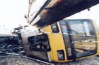 A photo of a train on its side following an accident